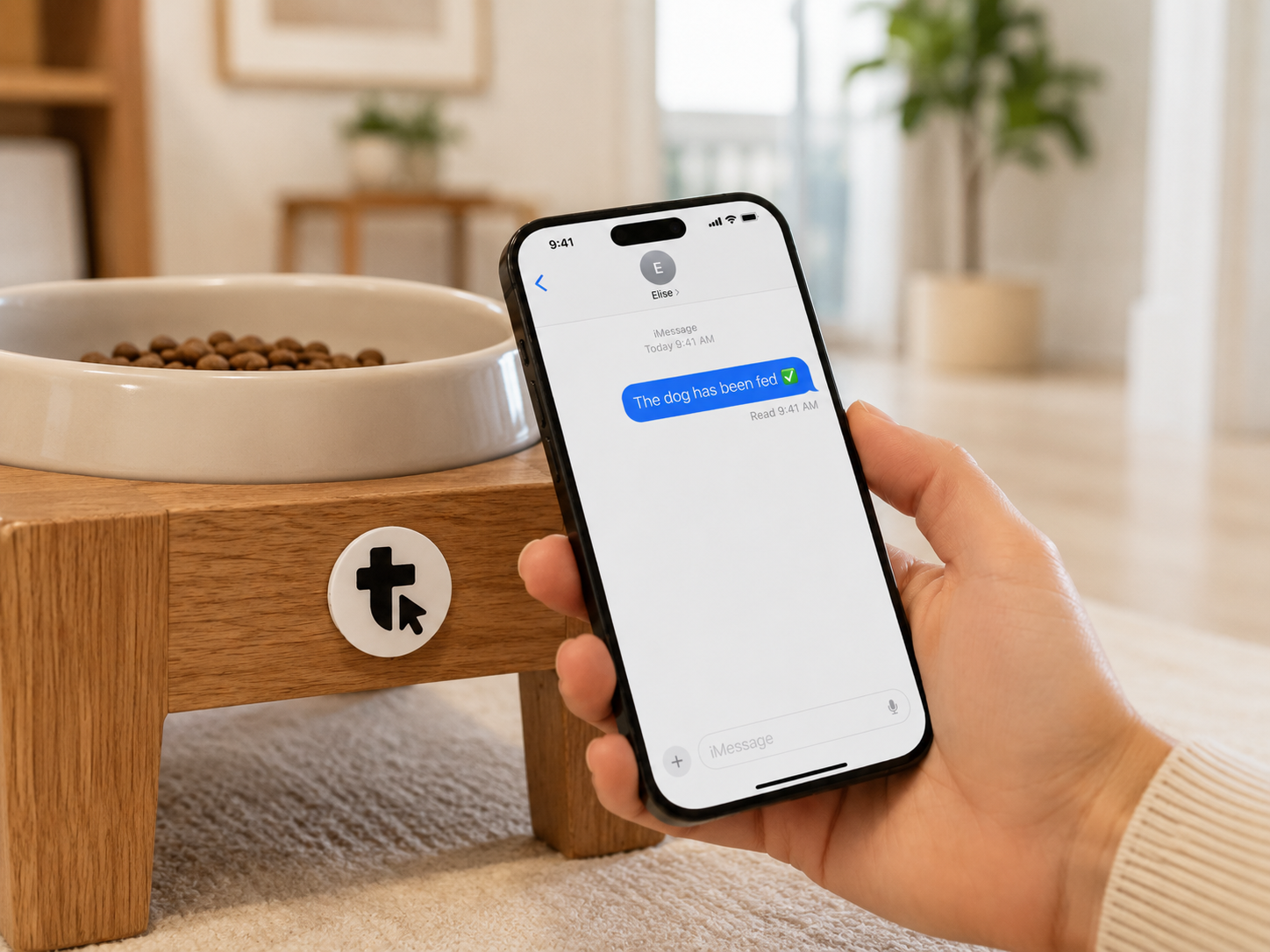 Tap on a dog bowl stand, phone confirming the dog was fed